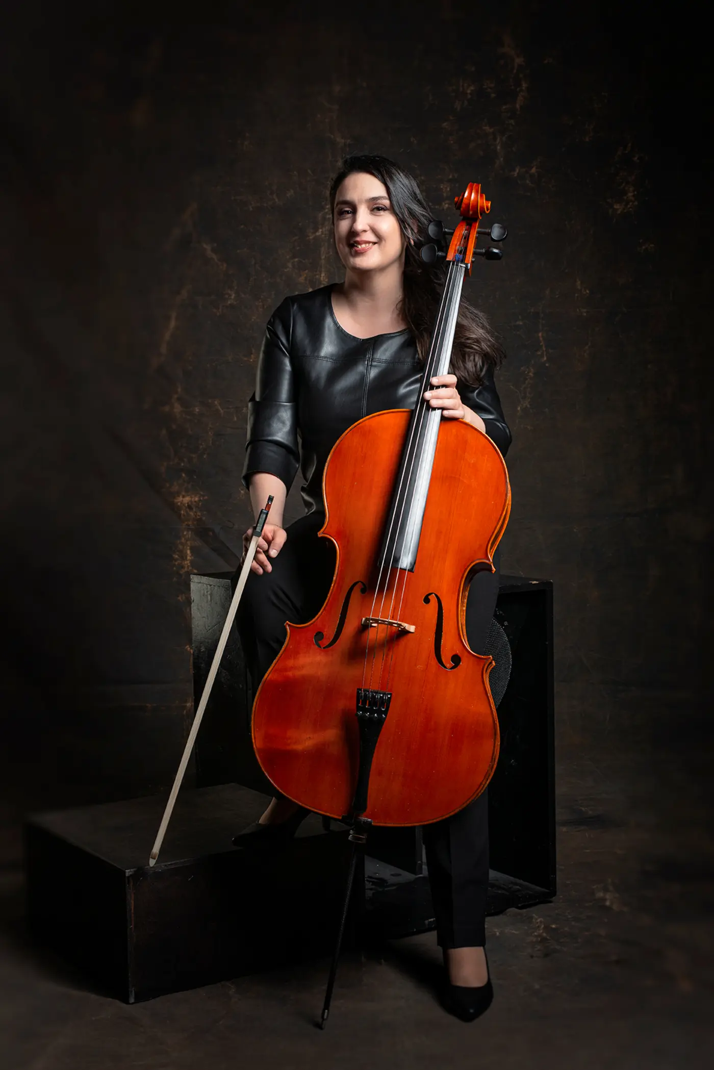 Irina Vylegzhanina standing with her cello